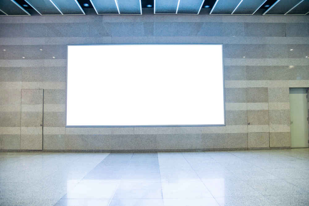 Blank billboard on the wall of pedestrian walkway