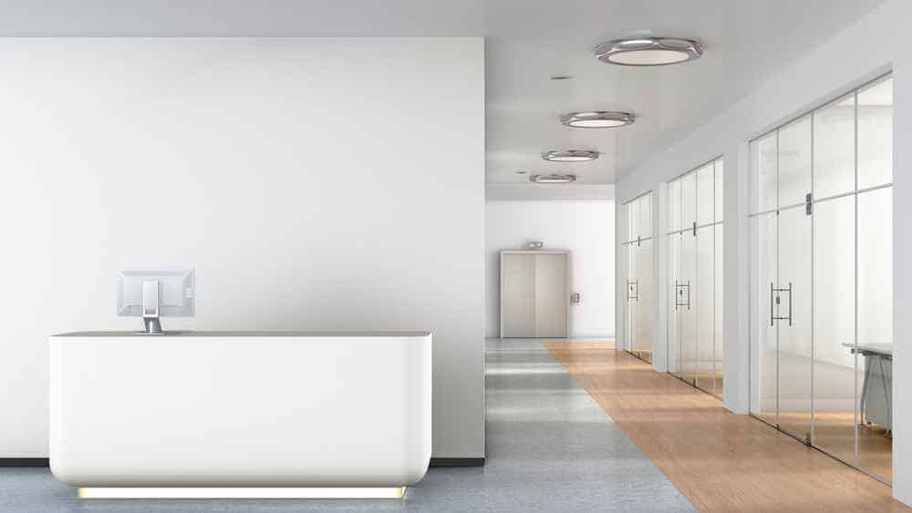 Reception desk in interior of empty business office lobby.