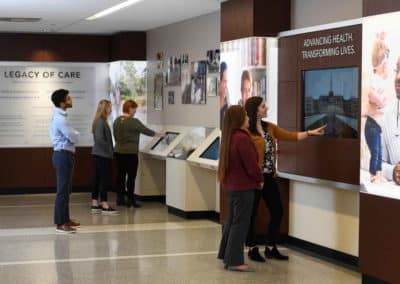 people viewing hospital lobby display