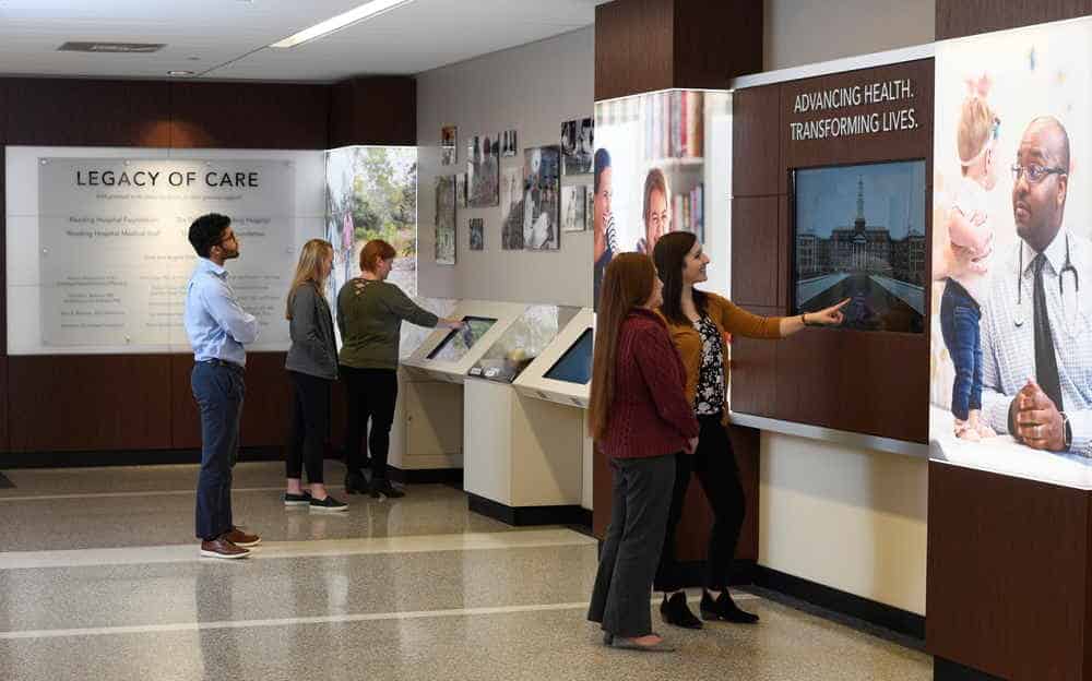 people viewing hospital lobby display