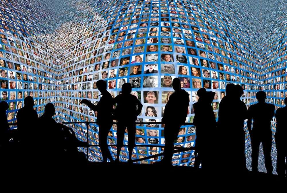 users silhouetted against endless screens social media concept