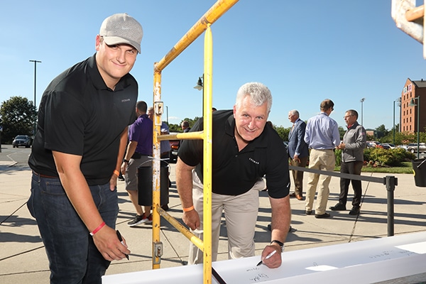 Showing staff and team signing I beam