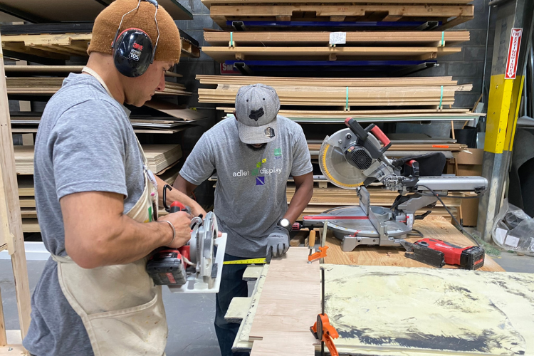 Adler Display crew working in the shop with saws